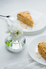 Napoleon millefeuille dessert pastry cream layers served on white plates with flower detail
