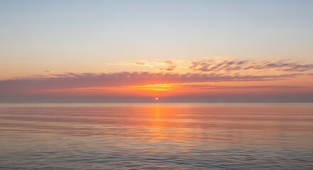 Serene ocean sunset with golden hues reflecting on calm water