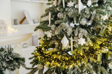Decorated evergreen branches with sparkling lights and festive ornaments create winter celebration