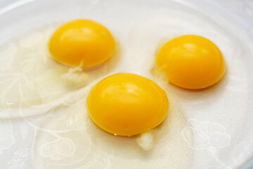Close up of a three egg yolks