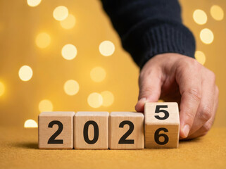 Background christmas colourful colours gold horse in festive bokeh background hand flips wooden date blocks from 2025 to 2026 evoking celebration and hopeful mood happy new year 2026 Concept