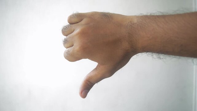 Sixteen frames show a hand with a thumbs down gesture, symbolizing disapproval, rejection, or disagreement, ideal for use in diverse contexts related to feedback and opinions.