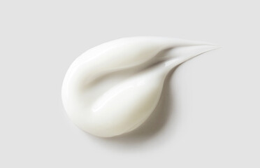 cosmetic smear of creamy texture on gray background