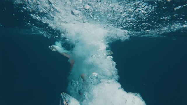 Person jumps into the sea from a boat