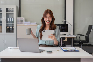 Business woman using tablet play social media in office.