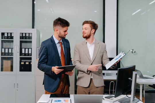 businessman collaborate on project analysis with financial graphs.