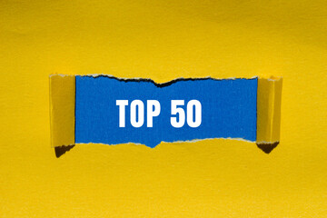 Top 50 message written on ripped torn paper background. Conceptual Top 50 symbol. Copy space.