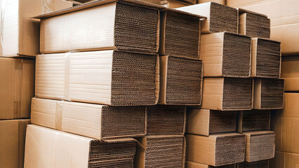Neatly stacked brown cardboard boxes shipping or storage in a warehouse or moving supplies