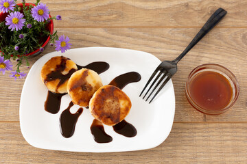 Curd fritters with chocolate and honey.
