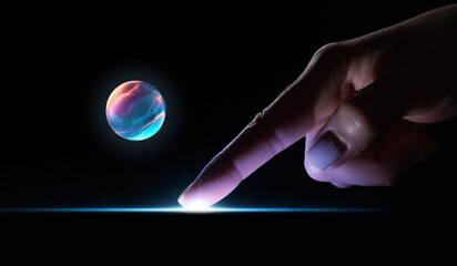 Finger activating glowing surface line with floating neon sphere. Concept of touch-based interfaces, futuristic interactions, holographic elements, and advanced digital control visuals.