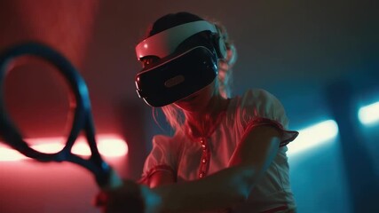 Person wearing a virtual reality headset and using a motion controller in a neon-lit room. - Powered by Adobe