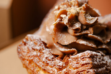 Flaky pastry topped with hazelnut cream and powder.