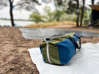 Camping tent bag on ground mat at campsite
