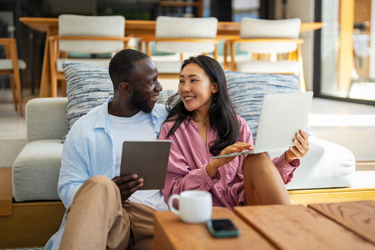 Man and woman working remotely using laptop. Male female freelancers working together. Digital nomad