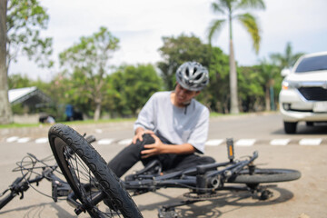 Bicyclist Injured After Accident Needs Medical Attention on Street Cyclist Clutches His Knee in Pain