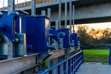 Blue Industrial Mechanisms On Metal Platform At Sunset For Engineering And Heavy Equipment Applications