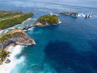 Aerial of dramatic coastal headland and offshore islets, Nusa Penida