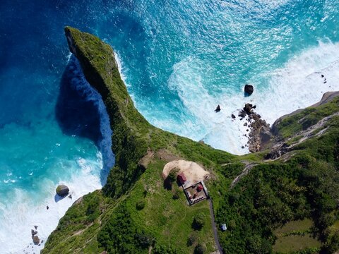 Aerial of iconic Kelingking cliff and crashing waves, Nusa Penida