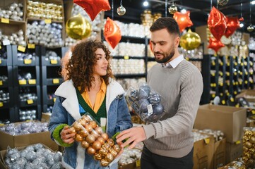 Couple shopping for christmas ornaments preparing for holidays