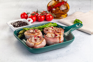 Tasty grilled pork medallion with bacon