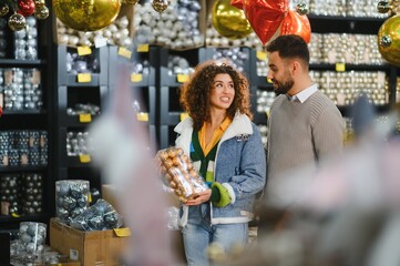 Couple shopping christmas tree ornaments in store