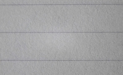 A macro shot of light gray paper revealing its texture. notebook sheet. notebook page