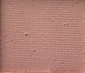 Pink eyeshadow surface in high-detail close-up photography