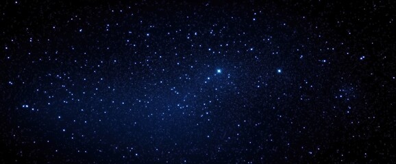 Obraz premium A vast night sky filled with sparkling stars, creating a breathtaking cosmic display against a deep blue backdrop.