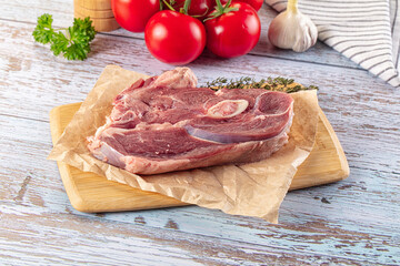 Raw lamb steak with bone