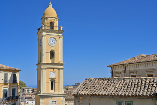 Rossano Torre dell'Orologio standing tall under blue sky. Rossano clock tower showing architectural details and traditional rooftops.