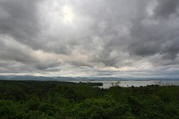 Overcast cloudy sky with dark clouds on a windy day over the lake