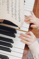hands of a girl with a white piano.