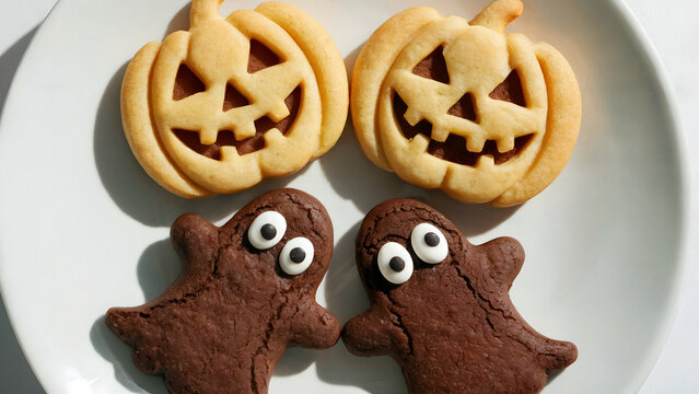 Delightful Halloween cookies shaped like pumpkins and friendly ghosts a spooky celebration