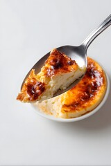 Spoonful of creamy Basque cheesecake with caramelized crust