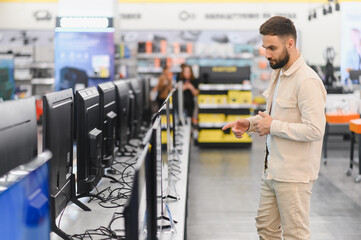 Customer choosing a new tv in electronics store