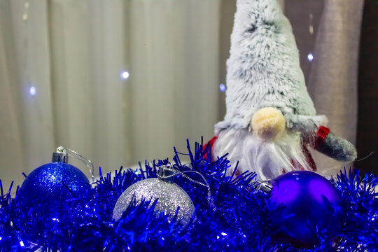 Blue rain with a gnome and Christmas tree decorations close-up, photo background, template, empty space for text, advertising banner, New Year, Christmas, 2026