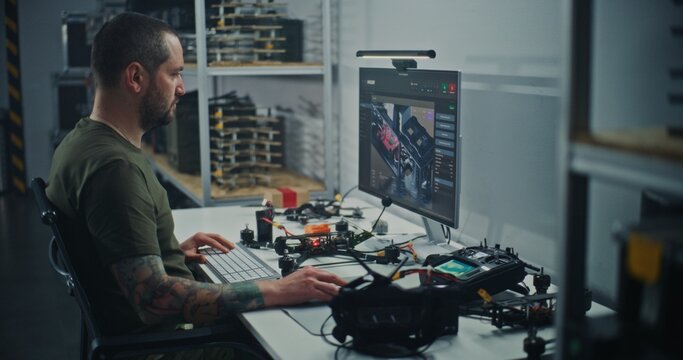 Technician Integrating Physical Drone With Digital Design Schematics. Man Comparing FPV Drone on Desk With 3D Schematics on Computer. Integration Digital and Physical Engineering in Drone Production.