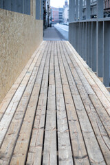 Wooden Construction Walkway Along Urban Street With Plank Flooring