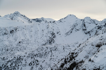 Mountain ridge and slopes covered with snow.