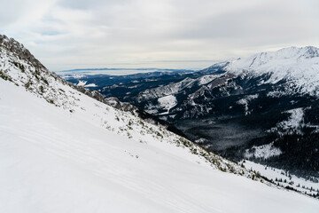 Winter panorama of mountains and valleys with fog.