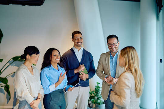 Business professionals engaged in an informal meeting, discussing new strategies, teamwork and company success