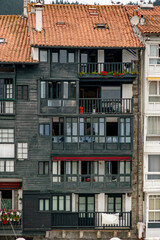 Fototapeta premium Traditional Dark Wood Facade and Balconies of Fishing Village Building in Bermeo