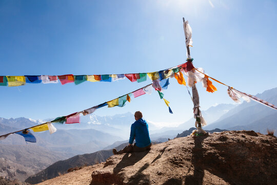 Man relaxing on mountain high pass, Upper Mustang, Nepal
