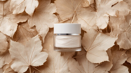 A small jar of cream is sitting on a leaf