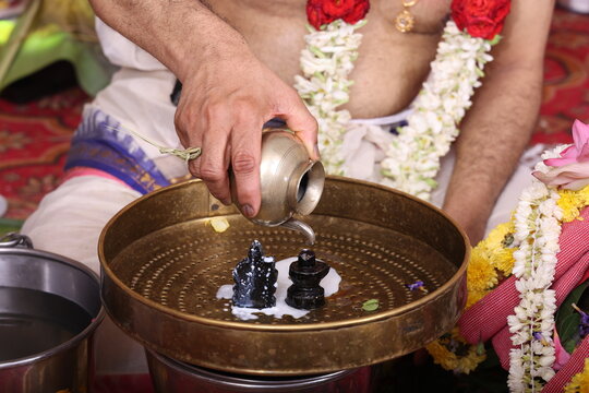 Performing Pooja for Hindu god siva linga with milk, honey and coconut water	