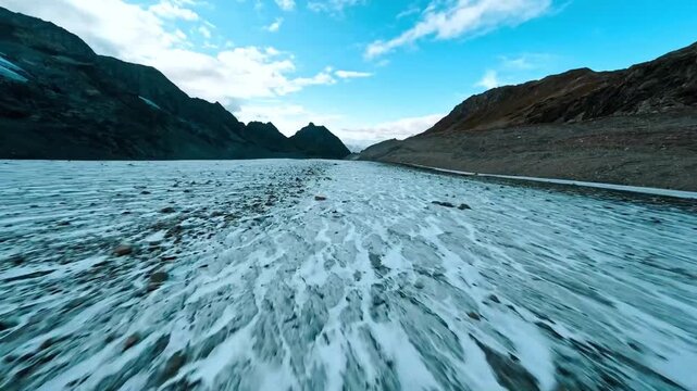 High-speed FPV drone flight skimming the surface of aglacier.