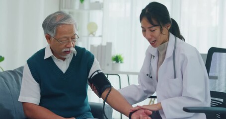Young Asia female doctor with old man patient using blood pressure consultation or cardiology wellness or hypertension, checkup or healthcare on sofa in health clinic office. Medical worker for care. - Powered by Adobe