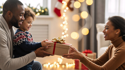 Happy african american family exchanging christmas gifts at home. Father and son giving a holiday present to the mother. Winter celebration concept
