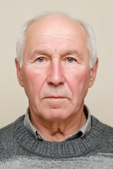 Neutral passport ID portrait of an elderly Russian Caucasian man wearing a gray sweater