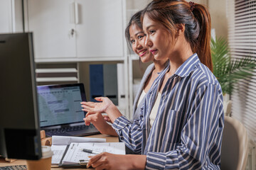 Young business women work online, learn new skills, home office team people collaborate, discussing project data shown on computer, female colleagues review monthly planner, planning future tasks